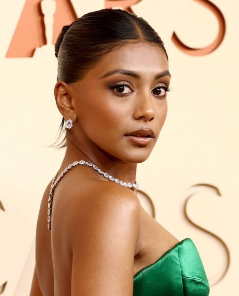 Charithra Chandran posing in a green strapless dress