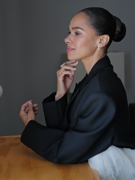 A profile photo of ballerina Misty Copeland before hte Oscars with her ballet bun and black jacket.
